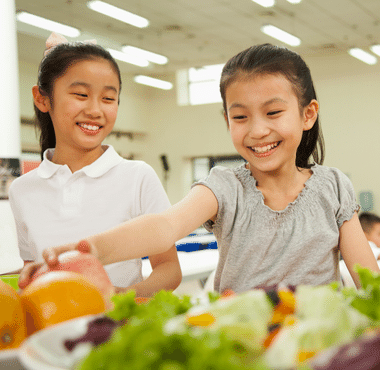 girl eating fruit school nutrition service catholic schools dayton cincinnati ohio